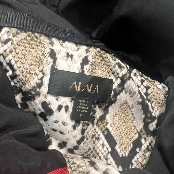 ALALA snakeskin anorak with red accents